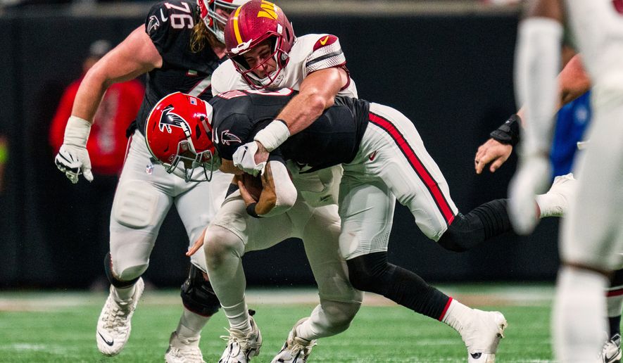 FILE - Washington Commanders defensive end Casey Toohill (95) sacks Atlanta Falcons quarterback Desmond Ridder (9) during the second half of an NFL football game, Oct. 15, 2023, in Atlanta. (AP Photo/Danny Karnik, File)