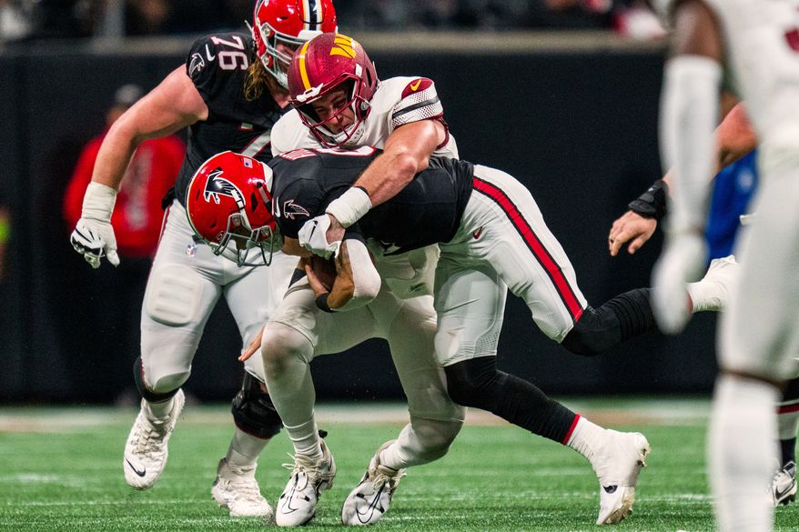 FILE - Washington Commanders defensive end Casey Toohill (95) sacks Atlanta Falcons quarterback Desmond Ridder (9) during the second half of an NFL football game, Oct. 15, 2023, in Atlanta. (AP Photo/Danny Karnik, File)