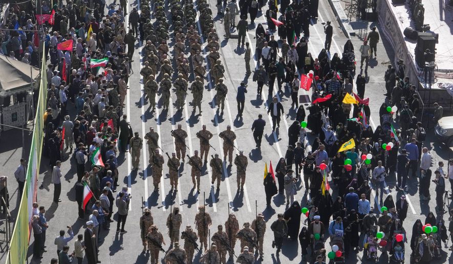 Members of Iran's Revolutionary Guard march through Revolution Square during the state-organized "Janfada," or "Sacrifice for Iran," military-style parade in Tehran, Iran, Friday, Sept. 18, 2026. (AP Photo/Vahid Salemi)