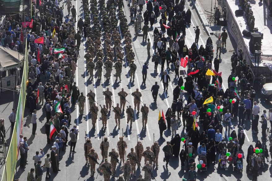 Members of Iran's Revolutionary Guard march through Revolution Square during the state-organized "Janfada," or "Sacrifice for Iran," military-style parade in Tehran, Iran, Friday, Sept. 18, 2026. (AP Photo/Vahid Salemi)