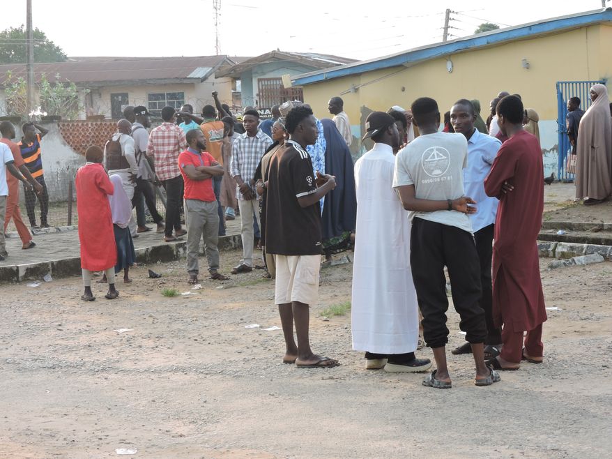 Families and relatives of miners who were arrested on suspicion of illegal mining wait outside a hospital where their bodies are stored in Minna, Nigeria, Thursday, Sept. 17, 2026. (AP Photo/Muhammed Nura)