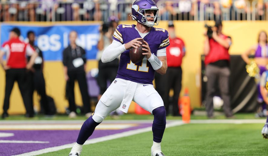 Minnesota Vikings quarterback Carson Wentz (11) drops back to pass during the first half of an NFL football game against the Green Bay Packers, Sunday, Sept. 13, 2026, in Minneapolis, Minn. (AP Photo/Bailey Hillesheim)