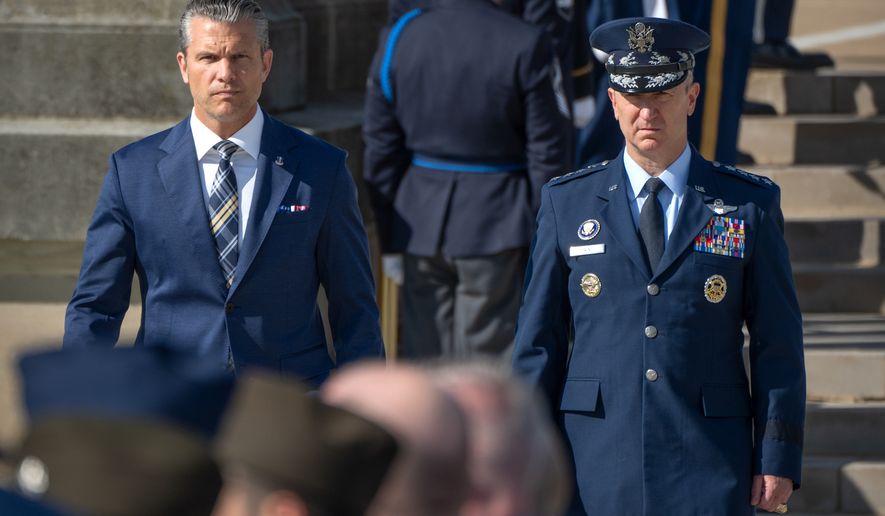 Defense Secretary Pete Hegseth, left, and Chairman of the Joint Chiefs of Staff Gen. Dan Caine, right, arrive for the POW/MIA National Recognition Day Ceremony at the Pentagon, Friday, Sept. 18, 2026, in Washington. (AP Photo/Mark Schiefelbein)