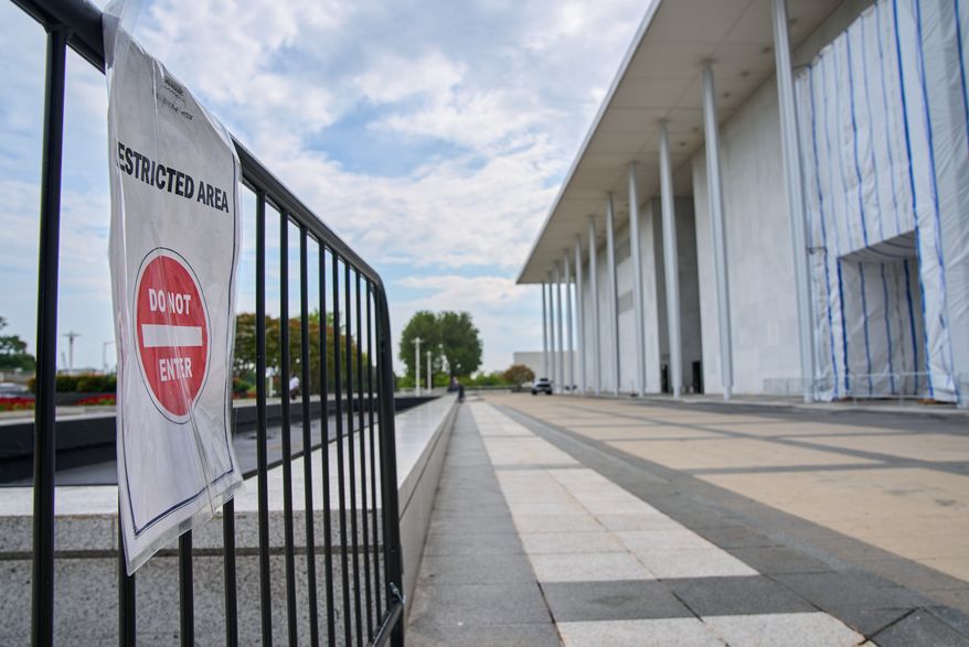 A sign directs people away from the Kennedy Center, which has been fenced off and closed to the public, Thursday, Sept. 17, 2026, in Washington. (AP Photo/Jacquelyn Martin)