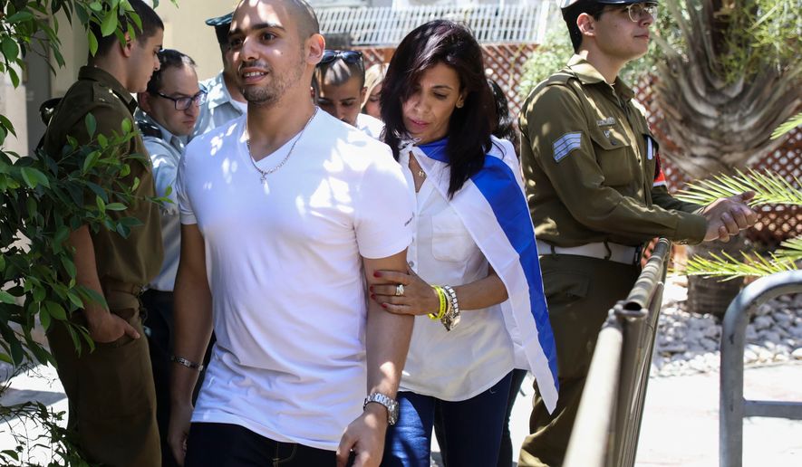 Elor Azaria escorted by his mother arrives to Israeli military court on July 30, 2017, in Tel Aviv, Israel. (AP Photo/Dan Balilty, Pool, File)