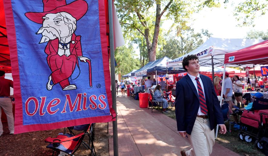 A student walks past the former mascot Col. Reb, on the University of Mississippi campus prior to their NCAA college football game against LSU in Oxford, Miss., Saturday, Sept. 19, 2026. (AP Photo/Rogelio V. Solis)