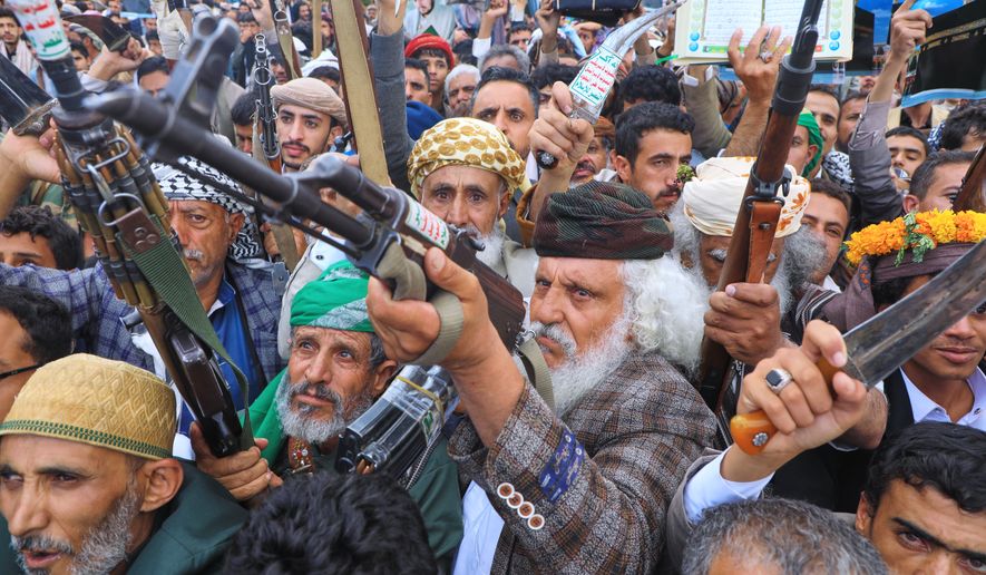 Supporters of Yemen's Houthi rebels raise their rifles during a rally in support of the group and to protest Saudi Arabia's accusation that the Houthis targeted Islam's holiest site of Mecca, in Sanaa, Yemen, Friday, Sept. 18, 2026. (AP Photo/Osamah Abdulrahman)