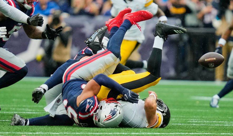 Pittsburgh Steelers quarterback Aaron Rodgers, right, is sacked by New England Patriots' Christian Elliss during the first half of an NFL football game against the New England Patriots, Sunday, Sept. 20, 2026, in Foxboro, Mass. (AP Photo/Charles Krupa)