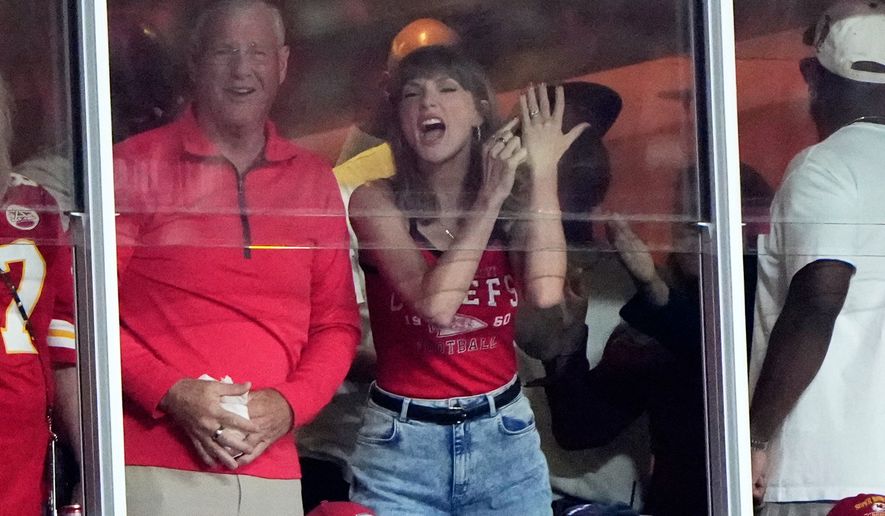 Taylor Swift celebrates with her father, Scott Swift, left, after a score by Kansas City Chiefs tight end Travis Kelce during the first half of an NFL football game between the Kansas City Chiefs and the Indianapolis Colts Sunday, Sept. 20, 2026, in Kansas City, Mo. (AP Photo/Charlie Riedel)