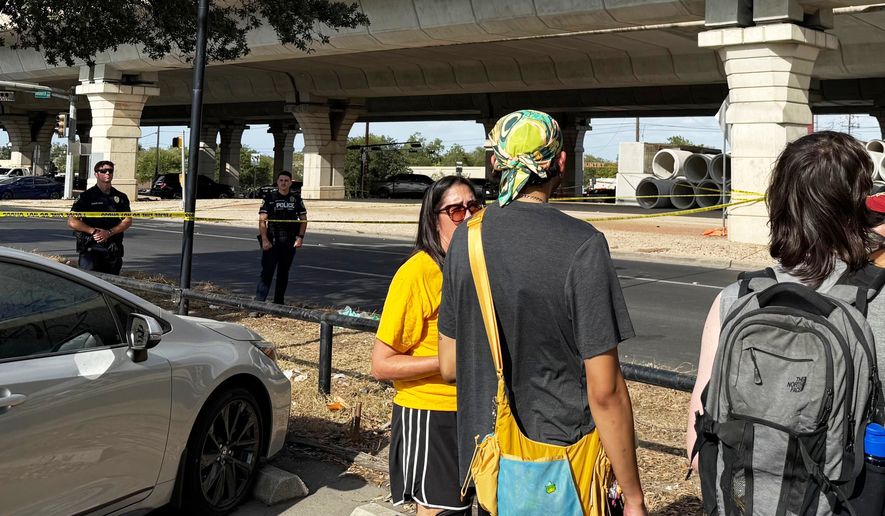 In this photo taken with a smart phone Police block a street after a shooting involving an ICE officer in Austin, Texas, Sunday, Sept. 20, 2026. (AP Photo/Jesse Bedayn)