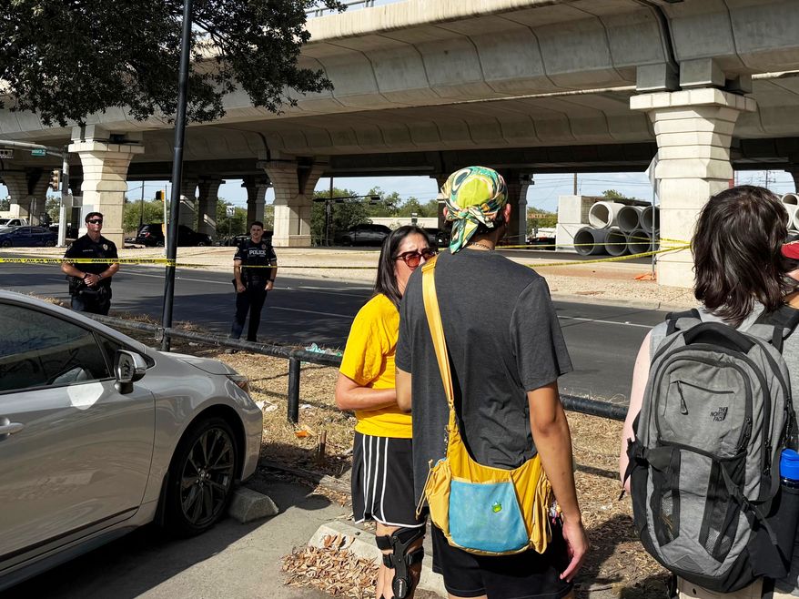 In this photo taken with a smart phone Police block a street after a shooting involving an ICE officer in Austin, Texas, Sunday, Sept. 20, 2026. (AP Photo/Jesse Bedayn)