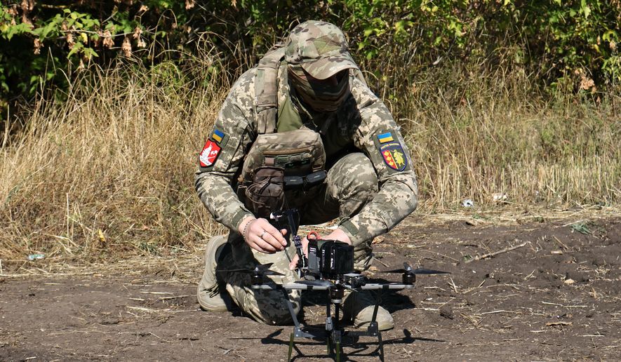 In this photo provided by Ukraine's 65th Mechanized Brigade press service, a Ukrainian soldier prepares an FPV drone to fire towards Russian positions in Zaporizhzhia region, Ukraine, Saturday, Sept. 19, 2026. (Andriy Andriyenko/Ukraine's 65th Mechanized Brigade via AP)