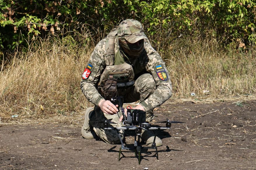 In this photo provided by Ukraine's 65th Mechanized Brigade press service, a Ukrainian soldier prepares an FPV drone to fire towards Russian positions in Zaporizhzhia region, Ukraine, Saturday, Sept. 19, 2026. (Andriy Andriyenko/Ukraine's 65th Mechanized Brigade via AP)