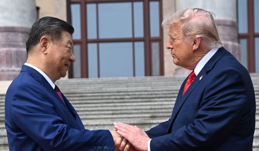Chinese President Xi Jinping, left, shakes hands with President Donald Trump at the Great Hall of the People in Beijing, May 14, 2026. (Kenny Holston/Pool Photo via AP, file)