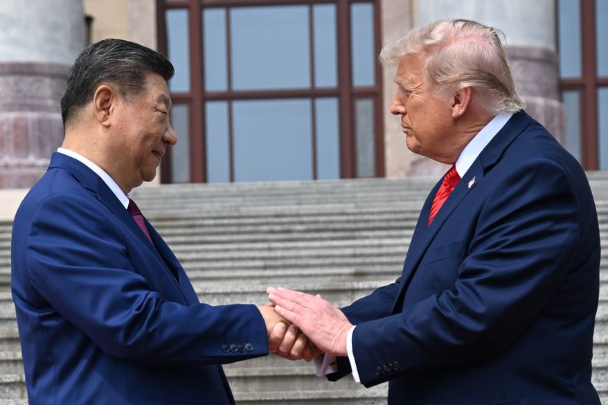 Chinese President Xi Jinping, left, shakes hands with President Donald Trump at the Great Hall of the People in Beijing, May 14, 2026. (Kenny Holston/Pool Photo via AP, file)