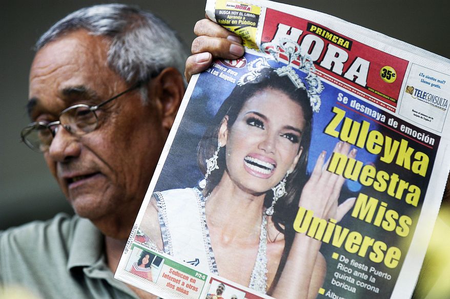 Retired teacher Manuel Colon Santiago, neighbor of the newly crowned Miss Universe Zuleyka Rivera Mendoza at her hometown of Salinas, Puerto Rico, shows a local newspaper with the headline: "Zuleyka our Miss Universe", Monday, July 24, 2006. People in this coastal town partied in the streets all night long to celebrate the crowning of the 18-year-old girl, after she was named Miss Universe late Sunday in Los Angeles. Several people in Salinas said Rivera, who grew up in a working-class neighborhood of small houses and narrow streets, never forgot her roots. (AP Photo/Herminio Rodriguez)