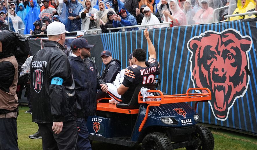 Chicago Bears quarterback Caleb Williams (18) waves as he is carted off the field after an injury during the second half of an NFL football game against the Minnesota Vikings in Chicago, Sunday, Sept. 20, 2026. (AP Photo/Nam Y. Huh)