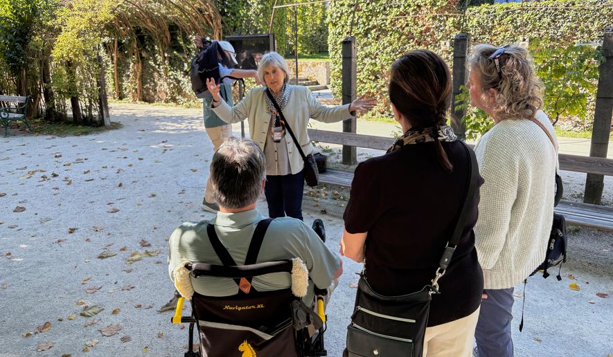 In this photo taken with a smartphone, Elisabeth von Trapp, center, guides visitors to locations of the musical film "The Sound of Music" in Salzburg, Austria, Sunday, Sept. 20, 2026. (AP Photo/Philipp-Moritz Jenne)