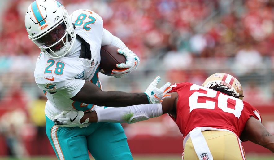 Miami Dolphins running back De'Von Achane (28) runs against San Francisco 49ers cornerback Upton Stout (20) during the first half of an NFL football game in Santa Clara, Calif., Sunday, Sept. 20, 2026. (AP Photo/Jed Jacobsohn)