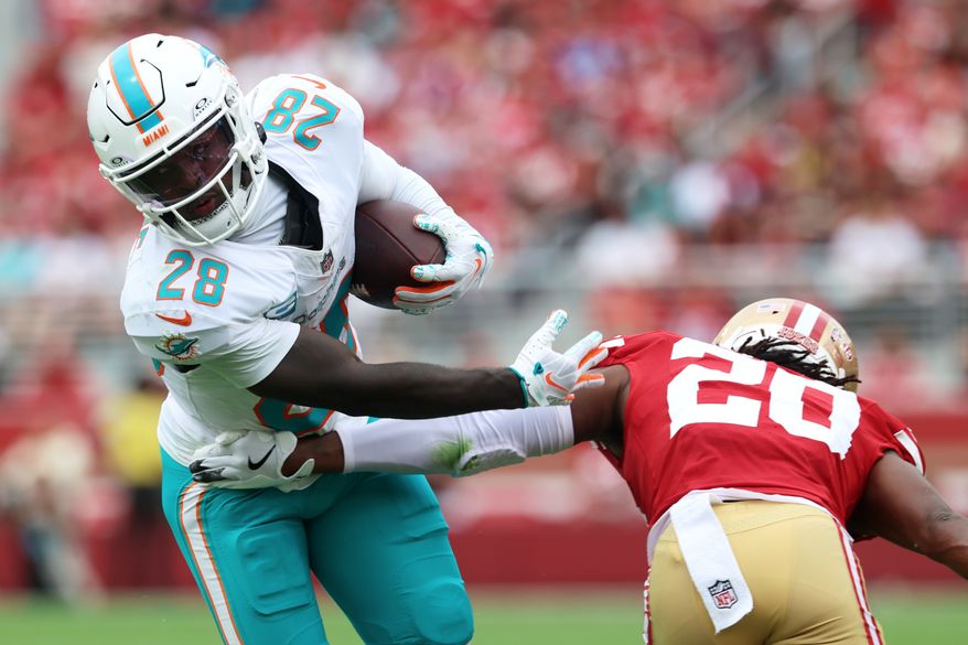 Miami Dolphins running back De'Von Achane (28) runs against San Francisco 49ers cornerback Upton Stout (20) during the first half of an NFL football game in Santa Clara, Calif., Sunday, Sept. 20, 2026. (AP Photo/Jed Jacobsohn)