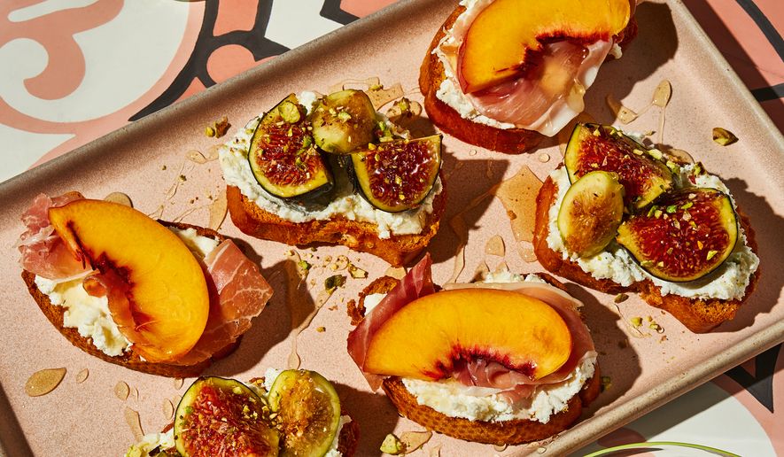 This image released by Voracious shows a recipe for crostini with seasonal fruit, ricotta, and honey from the cookbook "Stuzzichini" by Stef Ferrari. (Deepi Ahluwalia/Voracious via AP)