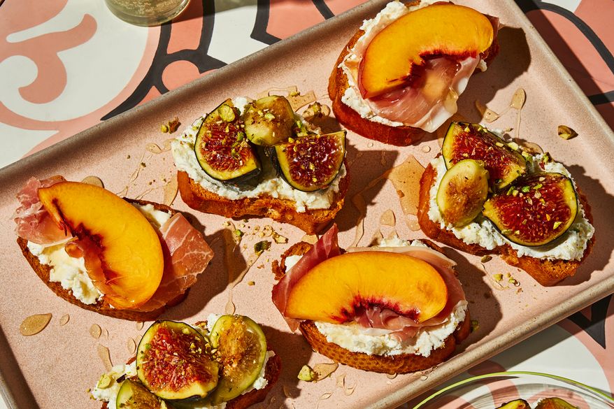 This image released by Voracious shows a recipe for crostini with seasonal fruit, ricotta, and honey from the cookbook "Stuzzichini" by Stef Ferrari. (Deepi Ahluwalia/Voracious via AP)