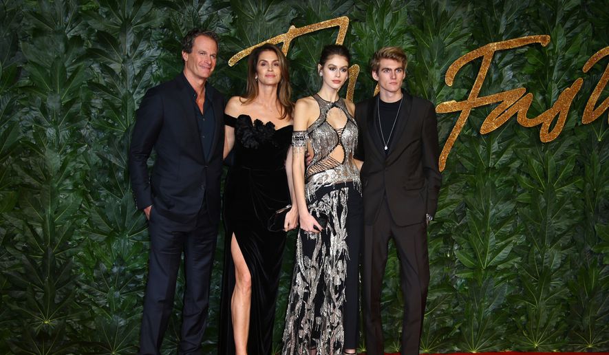 Businessman Rande Gerber, from left, models Cindy Crawford, Kaia Gerber and Presley Walker Gerber pose in central London, Monday, Dec. 10, 2018. (Photo by Joel C Ryan/Invision/AP, File)