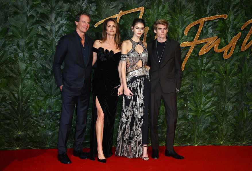 Businessman Rande Gerber, from left, models Cindy Crawford, Kaia Gerber and Presley Walker Gerber pose in central London, Monday, Dec. 10, 2018. (Photo by Joel C Ryan/Invision/AP, File)