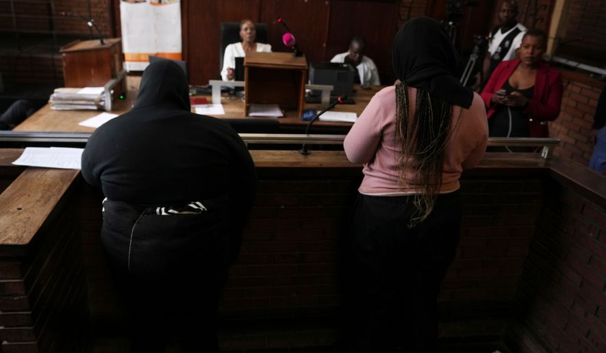 Two women appear in Boksburg Magistrate Court, east of Johannesburg, South Africa, Monday, Sept. 21, 2026, in connection with one of a series of killings of women in Johannesburg. (AP Photo/Themba Hadebe)
