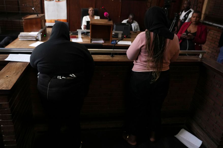 Two women appear in Boksburg Magistrate Court, east of Johannesburg, South Africa, Monday, Sept. 21, 2026, in connection with one of a series of killings of women in Johannesburg. (AP Photo/Themba Hadebe)