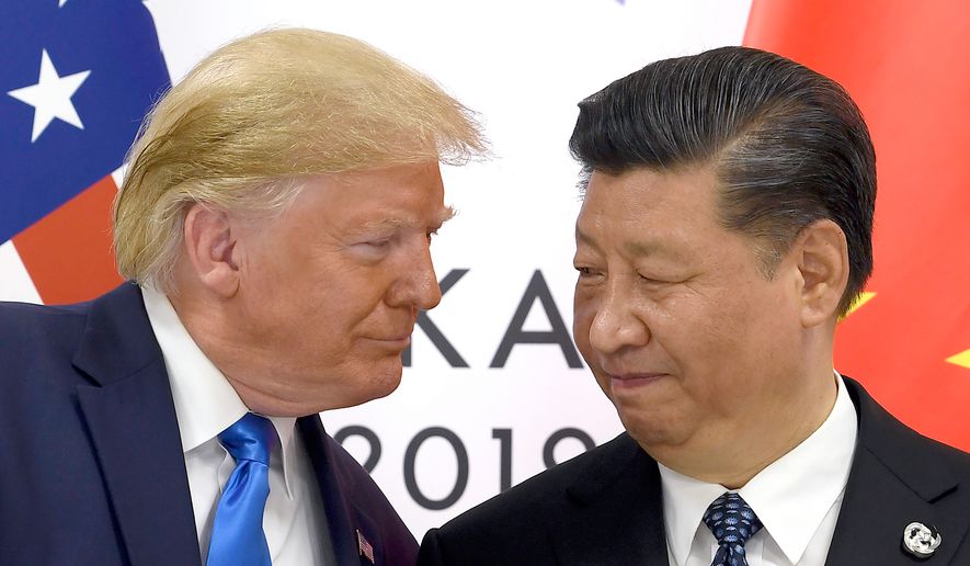 President Donald Trump, left, meets with Chinese President Xi Jinping during a meeting on the sidelines of the G-20 summit in Osaka, Japan, June 29, 2019. (AP Photo/Susan Walsh, File)