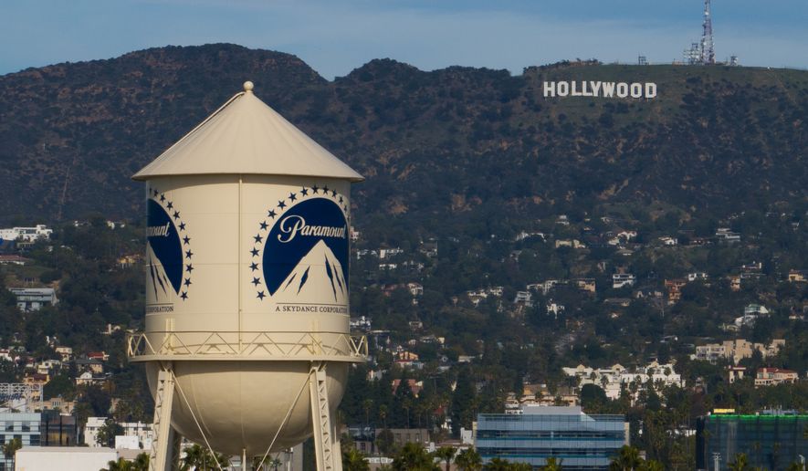 FILE - The Paramount Pictures water tower is seen in Los Angeles, Dec. 18, 2025, with the Hollywood sign in the distance. (AP Photo/Jae C. Hong, File)