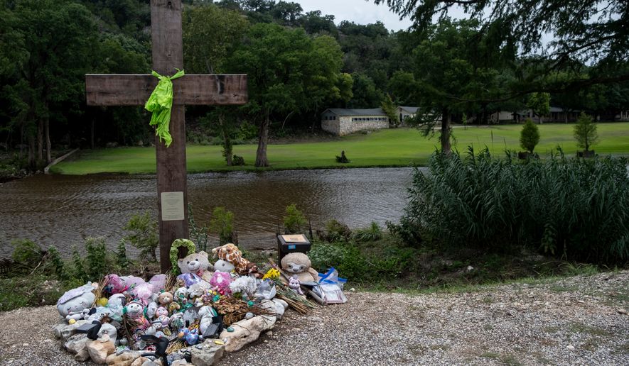 A memorial for the victims of the 2025 Camp Mystic flood stands, July 17, 2026, in Hunt, Texas. (AP Photo/Joel Angel Juarez, File)