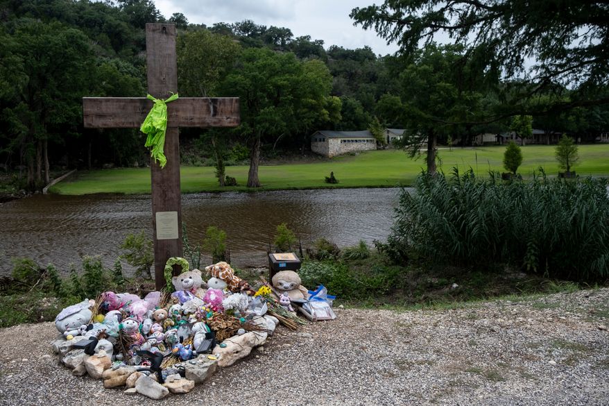 A memorial for the victims of the 2025 Camp Mystic flood stands, July 17, 2026, in Hunt, Texas. (AP Photo/Joel Angel Juarez, File)