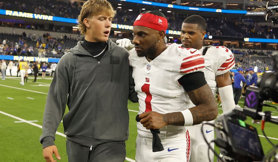 New York Giants quarterback Jaxson Dart, left, walks off the field with wide receiver Malik Nabers (1) after an NFL football game against the Los Angeles Rams in Inglewood, Calif., Monday, Sept. 21, 2026. (AP Photo/Caroline Brehman)