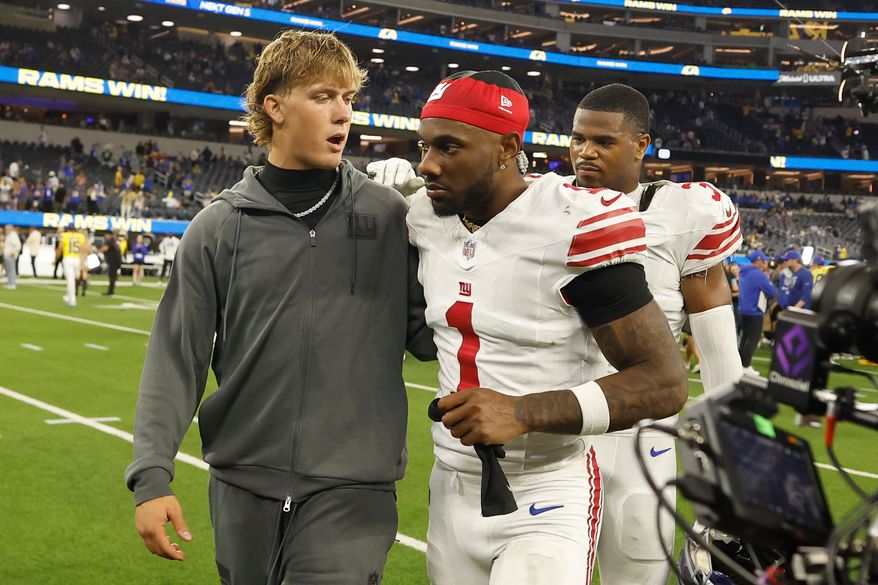 New York Giants quarterback Jaxson Dart, left, walks off the field with wide receiver Malik Nabers (1) after an NFL football game against the Los Angeles Rams in Inglewood, Calif., Monday, Sept. 21, 2026. (AP Photo/Caroline Brehman)