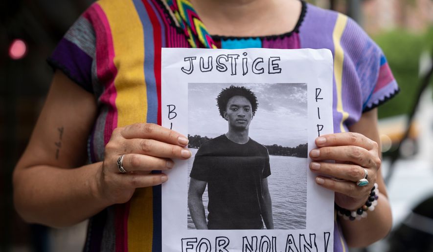 A person holds a picture of Nolan Xavier Wells during a news conference at National Action Network headquarters, Friday, July 10, 2026, in New York. (AP Photo/Yuki Iwamura, File)