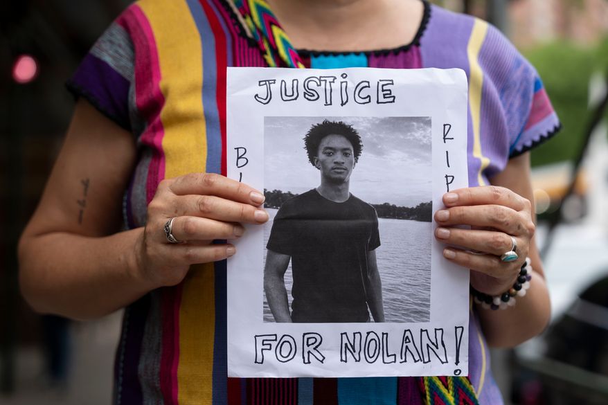 A person holds a picture of Nolan Xavier Wells during a news conference at National Action Network headquarters, Friday, July 10, 2026, in New York. (AP Photo/Yuki Iwamura, File)