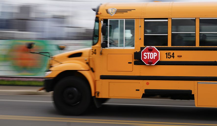 A school bus is driven in Philadelphia, Wednesday, Oct. 27, 2021. (AP Photo/Matt Rourke)