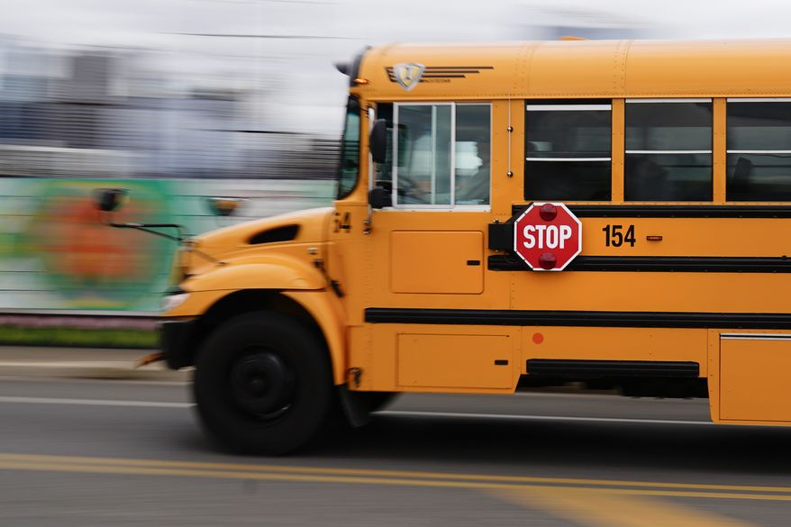 A school bus is driven in Philadelphia, Wednesday, Oct. 27, 2021. (AP Photo/Matt Rourke)