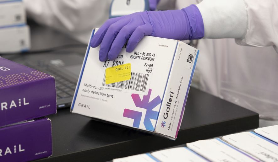 This undated photo provided by Grail Inc. on Tuesday, Sept. 22, 2026, shows an employee scanning a Galleri cancer screening test. (Grail Inc. via AP)