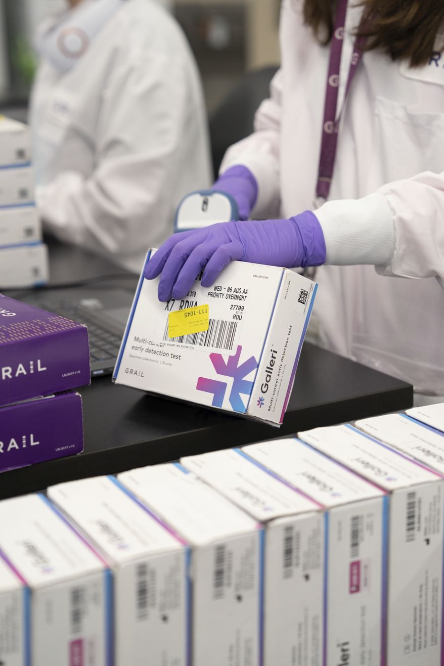 This undated photo provided by Grail Inc. on Tuesday, Sept. 22, 2026, shows an employee scanning a Galleri cancer screening test. (Grail Inc. via AP)