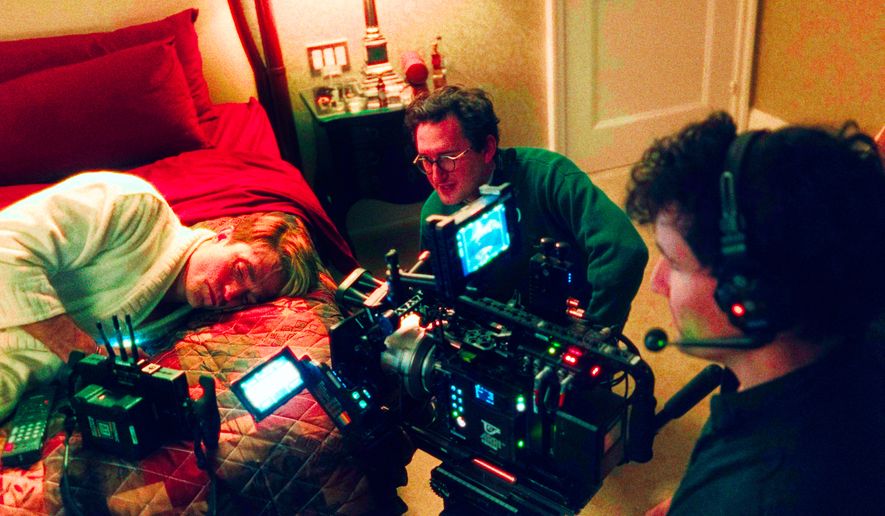 This image released by A24 shows Robert Pattinson, from left, director Lance Oppenheim, and cinematographer David Bolen during the filming of "Primetime." (A24 via AP)