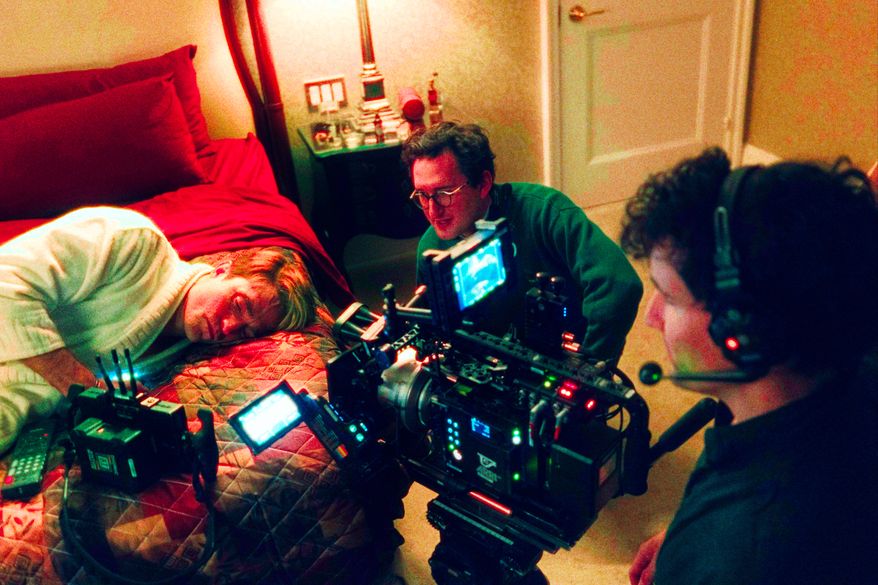 This image released by A24 shows Robert Pattinson, from left, director Lance Oppenheim, and cinematographer David Bolen during the filming of "Primetime." (A24 via AP)