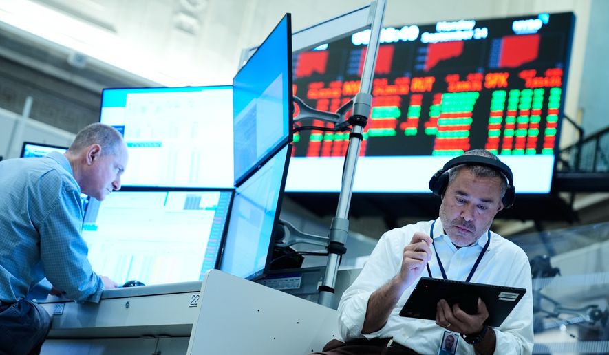 Justin Kanda works on the floor at the New York Stock Exchange in New York, Monday, Sept. 14, 2026. (AP Photo/Seth Wenig)