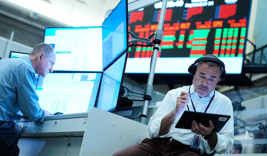 Justin Kanda works on the floor at the New York Stock Exchange in New York, Monday, Sept. 14, 2026. (AP Photo/Seth Wenig)