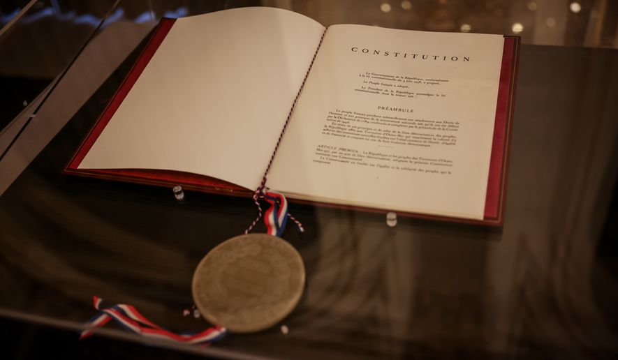 The text of the French Constitution is on display at the Elysee Palace in Paris on Saturday, Sept. 19, 2026. (AP Photo/Thomas Padilla)