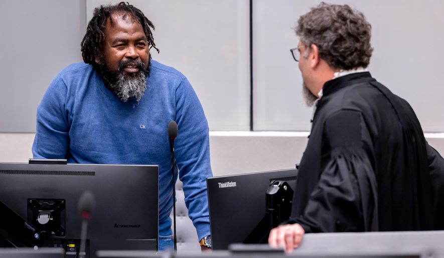Seleka rebel group commander Mahamat Said Abdel Kani, left, speaks with lawyer Dov Jacobs in the courtroom during a hearing in the case in which he is accused of crimes against humanity and war crimes allegedly committed in Bangui in 2013, in The Hague, Netherlands, Wednesday, Sept. 23, 2026. (Remko De Waal/Pool Photo via AP)