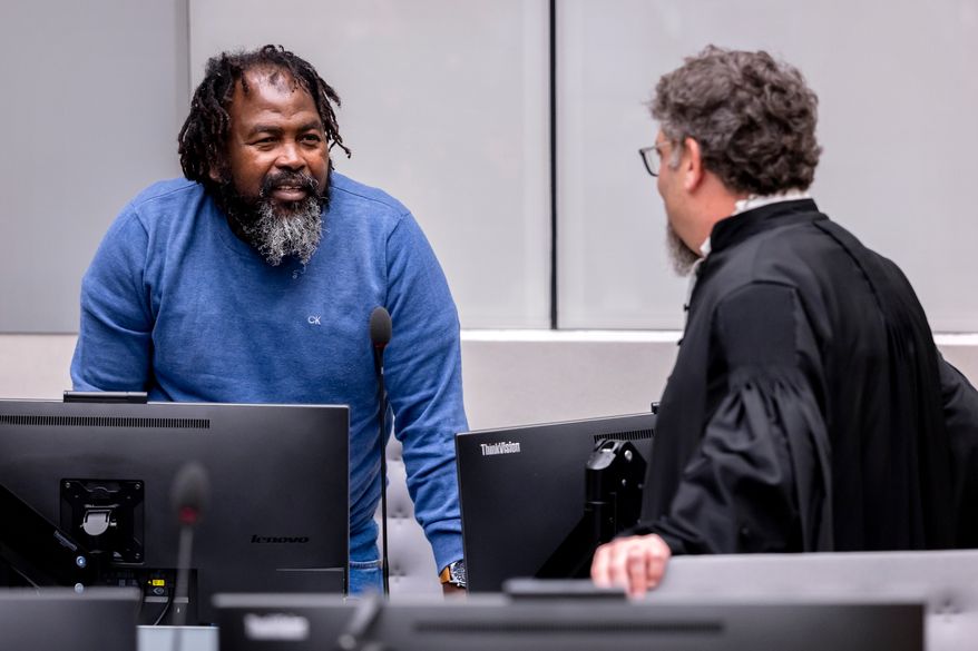 Seleka rebel group commander Mahamat Said Abdel Kani, left, speaks with lawyer Dov Jacobs in the courtroom during a hearing in the case in which he is accused of crimes against humanity and war crimes allegedly committed in Bangui in 2013, in The Hague, Netherlands, Wednesday, Sept. 23, 2026. (Remko De Waal/Pool Photo via AP)