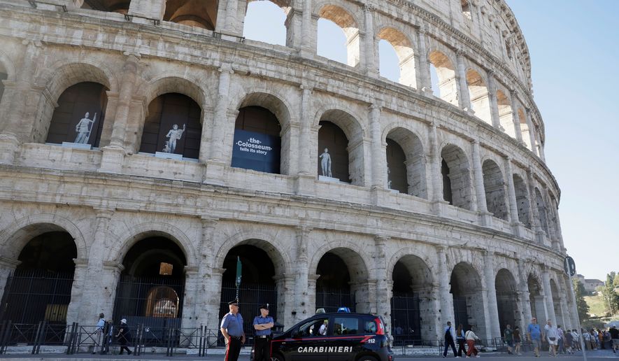 Carabinieri paramilitary police stand on patrol outside the Colosseum, closed to the public for the day to mourn a worker who fell to his death late Tuesday when installing cabling inside the ancient amphitheater, in Rome, Wednesday, Sept. 23, 2026. (Cecilia Fabiano/LaPresse via AP)